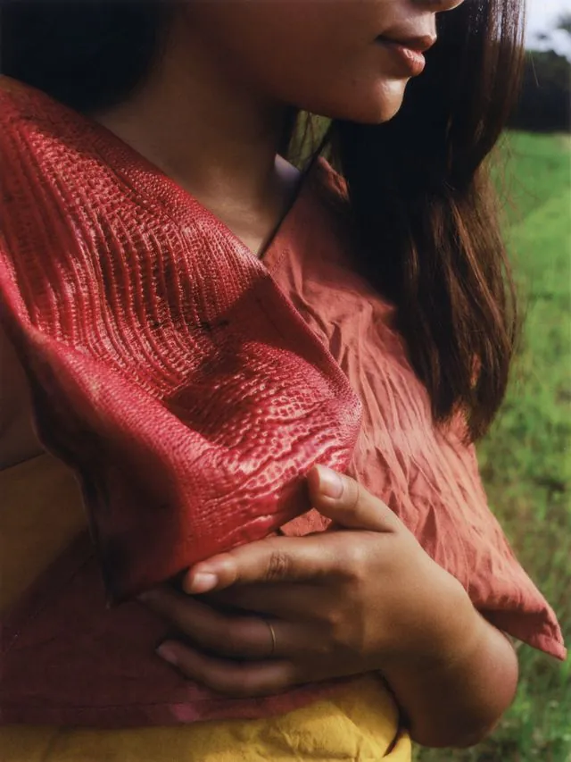 Woman with Red Fabric - Torso shot with reddish-orange textile